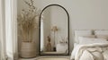 an elegant bedroom adorned with a large black arch mirror, accompanied by a small white wicker basket filled with items