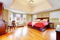 Elegant bedroom with cherrywood furniture set and high ceiling.