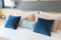 Bedroom interior with comfortable bed with pastel, blue and pink bedding Royalty Free Stock Photo