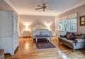 Elegant bedroom with wood floors and tasteful furniture Royalty Free Stock Photo