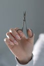 Elegant beige manicure with scissors in hand, professional nail technician work Royalty Free Stock Photo