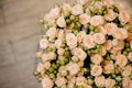 Elegant big bouquet of a lot of small roses of beige color close up