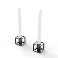 Elegant black candle holder with two white candles placed atop isolated on a white background Royalty Free Stock Photo