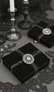 Elegant black gift boxes with silver accents on dark lace surface Royalty Free Stock Photo