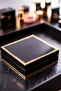 Elegant Black And Gold Compact Case Displayed On Textured Surface With Soft Defocused Background Royalty Free Stock Photo