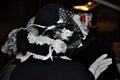 Elegant black lady hat with white detail of silk.Body part ,hand,covered with white glove