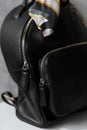 Elegant Black Leather Bag with Striped Scarf Detail