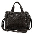 Elegant black leather woman`s handbag sewn from intertwined leather, isolated on white background, Women`s Fashion Bags