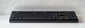 Elegant black mechanical keyboard positioned on a marble countertop for a sleek workspace look. Generative AI