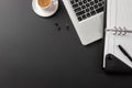 Elegant black office desktop with laptop and cup of coffee. Top view Royalty Free Stock Photo