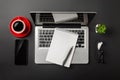 Elegant black office desktop with laptop, notebook, red cup of coffee and mobile phone