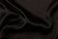Elegant black satin silk fabric material with subtle draperies. Top view Royalty Free Stock Photo