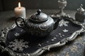 Elegant black teapot with intricate designs on vintage tray in candlelit setting Royalty Free Stock Photo