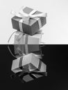 Elegant Black and White Still Life with Gift Boxes Featuring Reflective Surfaces Royalty Free Stock Photo