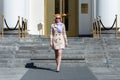 Elegant blond business woman in sun glasses walking