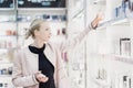 Beautiful woman shopping in beauty store. Royalty Free Stock Photo