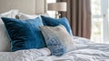 Elegant blue pillows on white bed in a cozy French country interior Royalty Free Stock Photo