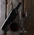 Elegant bottle and glasses of tasty fragrant red wine on wooden background. Advertising and promotion concept. Mock up. Flat lay. Royalty Free Stock Photo