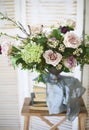 Elegant bouquet of pink flowers and ancient books Royalty Free Stock Photo