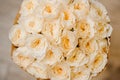 Elegant bouquet of roses of beige color close up on white background