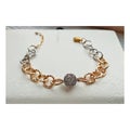 Elegant bracelet with a large chain on a light background. Combination of gold and silver colors.