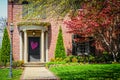 Elegant brick home with curved front entrance with pillars and beautiful landscaping and standing yard lanturn with Valentine Royalty Free Stock Photo