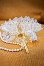 Elegant bride garter and pearls necklace Royalty Free Stock Photo