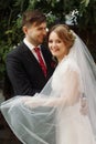 elegant bride and groom smiling in european city street at evening. luxury emotional wedding couple having fun. romantic sensual Royalty Free Stock Photo