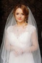 elegant bride portrait while she is posing under veil in old courtyard in european street. luxury wedding couple. romantic