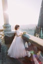 Elegant bride poses on the tower balcony of old gothic cathedral Royalty Free Stock Photo