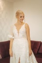 Elegant bride in wedding dress at home. Lond white dress on fantastic girl