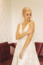 Elegant bride in wedding dress at home. Lond white dress on fantastic girl