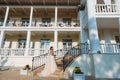 Elegant bride with wedding flowers bouquet, attractive woman in wedding dress. Young girl in a white dress goes the Royalty Free Stock Photo