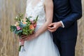 Elegant bride in white dress with lace holding bridal bouquet of Royalty Free Stock Photo