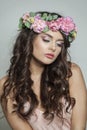 Elegant brunette woman with fresh flower on her head. Spring, cosmetic, beauty, skin care and hair care concept