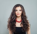 Elegant brunette woman model with makeup, curly long hair and red coral necklace Royalty Free Stock Photo