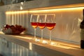 Elegant burgundy wine glasses on a warm lit wooden shelf Royalty Free Stock Photo