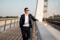 Elegant businessman in suit standing by the railroad on the bridge Royalty Free Stock Photo