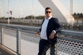 Elegant businessman in suit standing by the railroad on the bridge Royalty Free Stock Photo