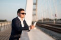 Elegant businessman using smartphone on the bridge Royalty Free Stock Photo