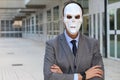 Elegant businessman wearing a horrible mask Royalty Free Stock Photo