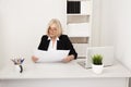 Elegant businesswoman in glassess working in the white office with paper.