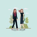 Elegant businesswomen walking in the park