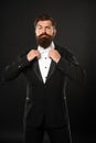 elegant butler in tuxedo on black background, bow tie Royalty Free Stock Photo