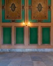 Elegant carved green frames on orange wall with ornate border and lanterns over marble floor Royalty Free Stock Photo