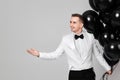caucasian man in white suit tuxedo with black air balloons Royalty Free Stock Photo