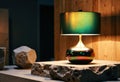 Elegant ceramic table lamp with a colorful glaze on a rustic stone surface Royalty Free Stock Photo
