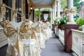 elegant chair covers and bows on the front porch of a decorated home