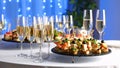 Elegant champagne flutes and appetizers on a table at a celebration event. Royalty Free Stock Photo