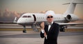 Elegant chef gesturing in front of private jet